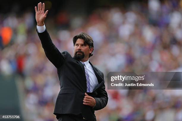 Former first baseman Todd Helton of the Colorado Rockies waves to the crowd during a ceremony to retire his number before a game against the...