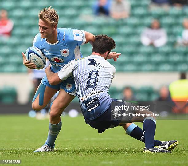 Heinrich Viljoen of Blue Bulls is tackled by Owen Jenkins of Cardiff during the Plate Trophy Final match between Cardiff Blues and Vodacom Blue Bulls...