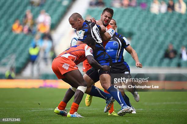 Denis Simplikevich of RC Enisei is tackled by Marcus Henderson and Sean Rafferty of New York during the 7th / 8th Place match between RC Enisei and...
