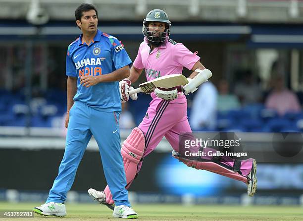 Hashim Amla of South Africa runs past Mohit Sharma of India during the 1st Momentum ODI match between South Africa and India at Bidvest Wanderers...
