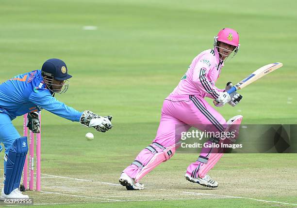 Quointon de Kock of South Africa plays past MS Dhoni of India during the 1st Momentum ODI match between South Africa and India at Bidvest Wanderers...