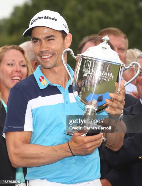 Camilo Villegas of Colombia poses with the Sam Snead Cup after winning the Wyndham Championship at Sedgefield Country Club on August 17, 2014 in...