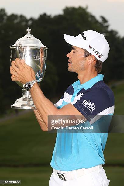 Camilo Villegas of Colombia poses with the Sam Snead Cup after winning the Wyndham Championship at Sedgefield Country Club on August 17, 2014 in...
