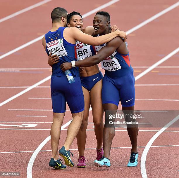 Adam Gemili and Harry Aikines-Aryeetey celebrate with Ashleigh Nelson of Great Britain after her team wins the Women's 4x100 metres relay final...