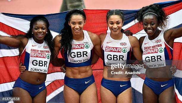 Asha Philip, Ashleigh Nelson, Jodie Williams and Desiree Henry of Great Britain pose after winning the Women's 4x100 metres relay final during day...