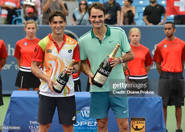 David Ferrer and Roger Federer celebrate with Moet & Chandon, the official champagne of the Western & Southern Open, following Federers victory of...