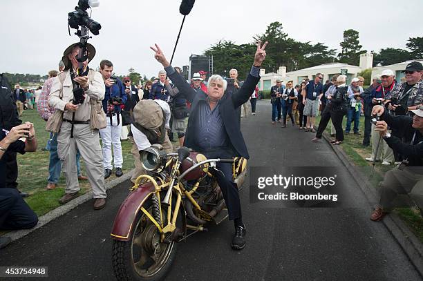 Entertainer Jay Leno reacts after riding a 1930 Bohmerland motorcycle during the 2014 Pebble Beach Concours d'Elegance in Pebble Beach, California,...