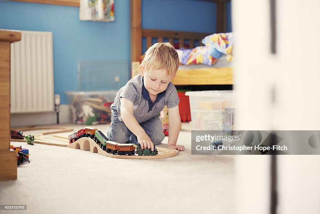 Boy playing with toy trains