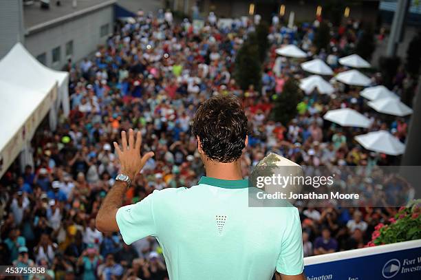 Roger Federer of Switzerland poses with the winner's trophy on Champion's Balcony after a final match against David Ferrer of Spain on day 9 of the...