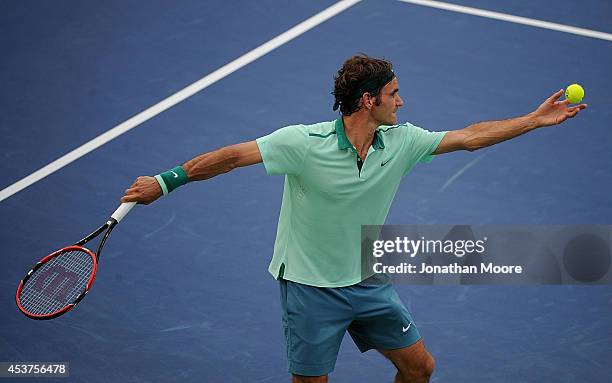 Roger Federer of Switzerland serves against David Ferrer of Spain during a final match on day 9 of the Western & Southern Open at the Linder Family...