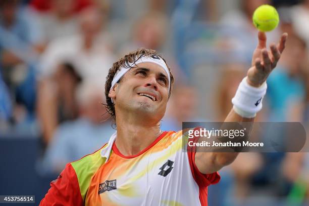 David Ferrer of Spain serves against Roger Federer of Switzerland during a final match on day 9 of the Western & Southern Open at the Linder Family...