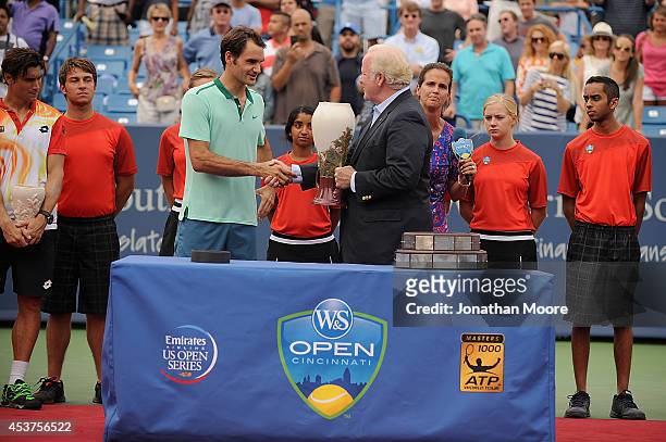 Roger Federer of Switzerland is presented the winner's trophy by John F. Barrett, Chairman, President and Chief Executive Officer of Western &...