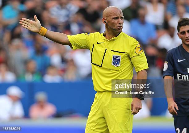 Referee Amaury Delerue gestures during the French Ligue 1 match between Paris Saint Germain FC and SC Bastia at Parc des Princes stadium on August...