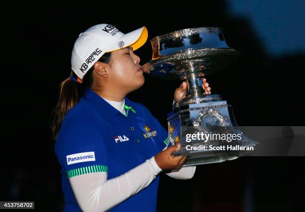 Inbee Park of South Korea celebrates with the trophy after winning theWegmans LPGA Championship at Monroe Golf Club on August 17, 2014 in Pittsford,...