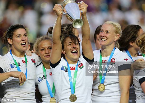 Captain of England Katy McLean lifts the trophy with teammates to celebrate the victory in the IRB Women's Rugby World Cup 2014 Final between England...