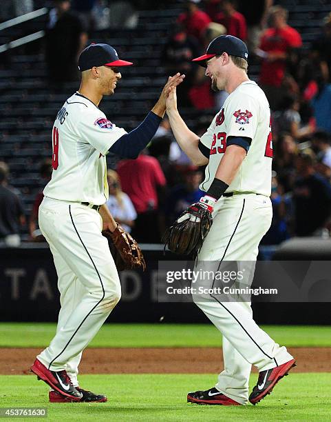 Andrelton Simmons and Chris Johnson of the Atlanta Braves celebrate after the game against the Oakland Athletics at Turner Field on August 17, 2014...