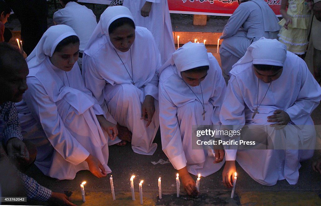 Pakistani Christian community light candles in the memory of...