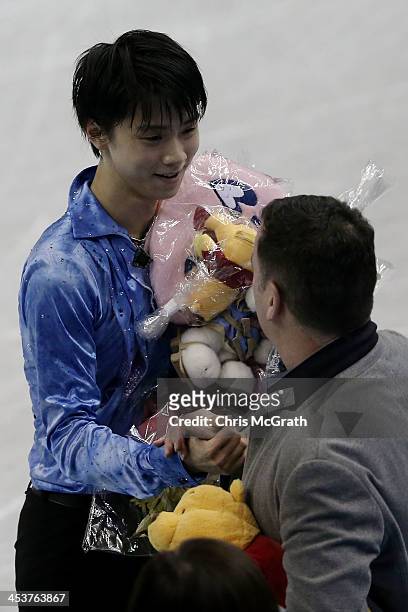 Yuzuru Hanyu of Japan is congratulated by coach Brian Orser after competing in the Men's Short Program during day one of the ISU Grand Prix of Figure...