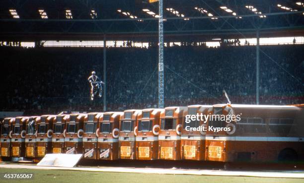 American daredevil Evel Knievel makes a motorcycle jump over thirteen AEC Merlin buses at Wembley Stadium in London, 26th May 1975. The stunt ended...