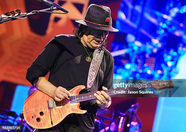 Musician Carlos Santana performs at Sprint Center on August 14, 2014 in Kansas City, Missouri.