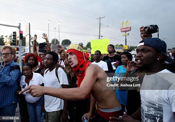 Demonstrators protesting the shooting death of teenager Michael Brown by police yell at Missouri State Highway Patrol Captain Ronald Johnson on...