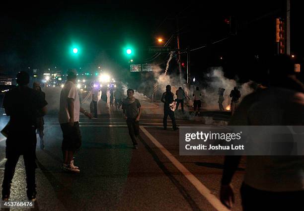 Demonstrators protesting the shooting death of teenager Michael Brown by police are tear gassed by police on August 17, 2014 in Ferguson, Missouri....