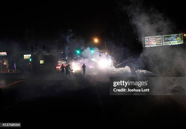 Demonstrators protesting the shooting death of teenager Michael Brown by police are tear gassed by police August 17, 2014 in Ferguson, Missouri....