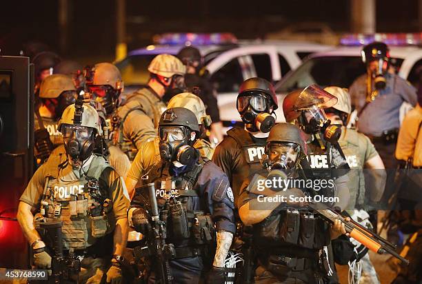 Police advance on demonstrators protesting the killing of teenager Michael Brown on August 17, 2014 in Ferguson, Missouri. Police shot smoke and tear...
