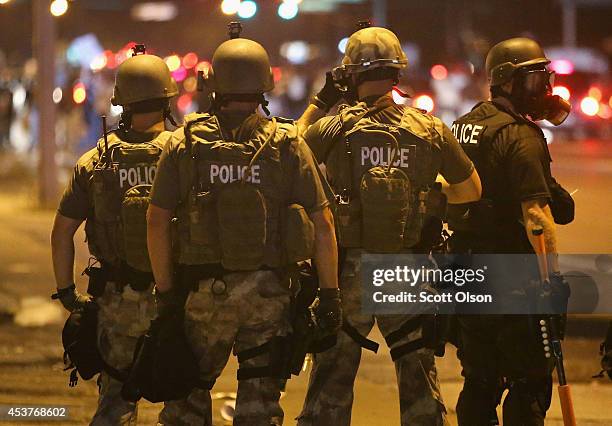 Police advance on demonstrators protesting the killing of teenager Michael Brown on August 17, 2014 in Ferguson, Missouri. Police shot smoke and tear...