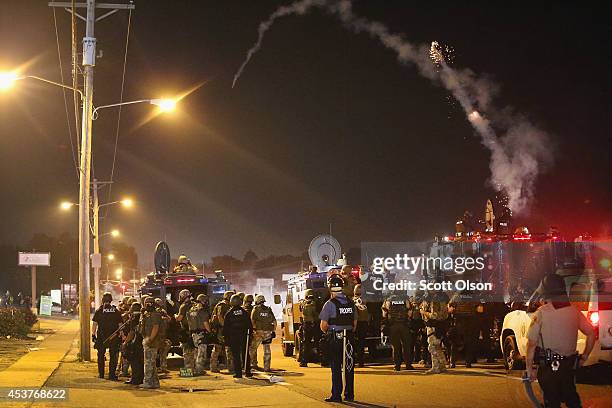Police launch tear gas at demonstrators protesting the killing of teenager Michael Brown on August 17, 2014 in Ferguson, Missouri. Police shot smoke...