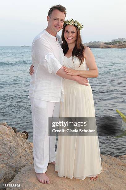 Holger Stromberg and his wife Nikita pose during their wedding on August 9, 2014 in Ibiza, Spain.