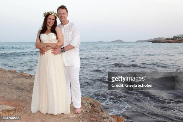 Holger Stromberg and his wife Nikita pose during their wedding on August 9, 2014 in Ibiza, Spain.