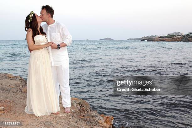 Holger Stromberg and his wife Nikita pose during their wedding on August 9, 2014 in Ibiza, Spain.