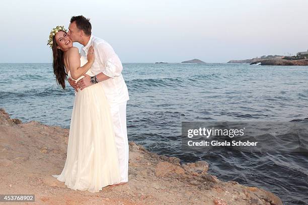 Holger Stromberg and his wife Nikita pose during their wedding on August 9, 2014 in Ibiza, Spain.