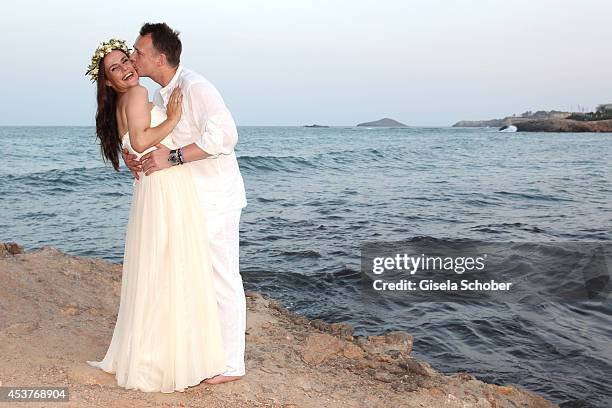 Holger Stromberg and his wife Nikita pose during their wedding on August 9, 2014 in Ibiza, Spain.