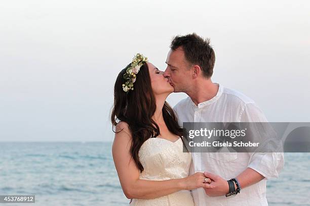 Holger Stromberg and his wife Nikita pose during their wedding on August 9, 2014 in Ibiza, Spain.