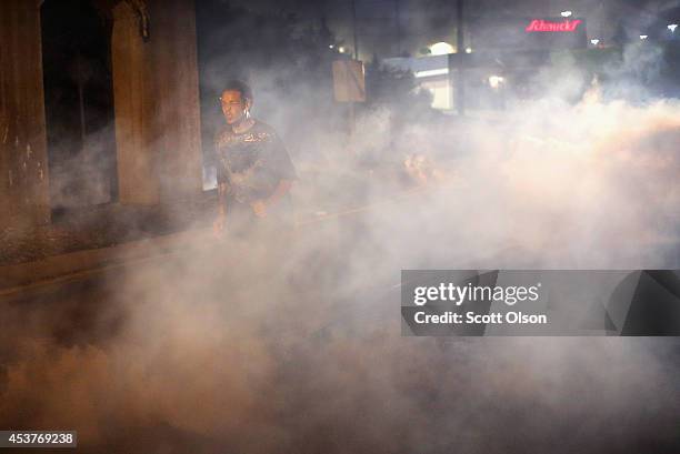 Tears gas fills the street during a demonstration over the killing of teenager Michael Brown by a Ferguson police officer on August 17, 2014 in...