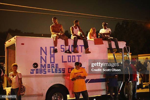 Demonstrators protest the killing of teenager Michael Brown on August 17, 2014 in Ferguson, Missouri. Despite the Brown family's continued call for...