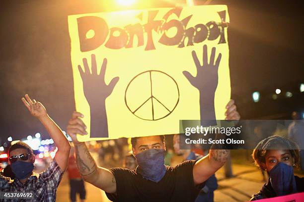 Demonstrators hold up a 'don't shoot' sign during a protest at the killing of teenager Michael Brown on August 17, 2014 in Ferguson, Missouri....