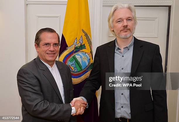 WikiLeaks founder Julian Assange shake hands with Ecuadorian Foreign Minister Ricardo Patino after a press conference, where he confirmed he "will be...