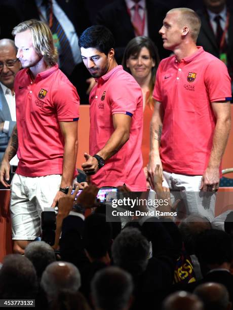 Ivan Rakitic, Luis Suarez and Jeremy Mathieu of FC Barcelona acknowledge the FC Barcelona supporters during the new FC Barcelona players presentation...