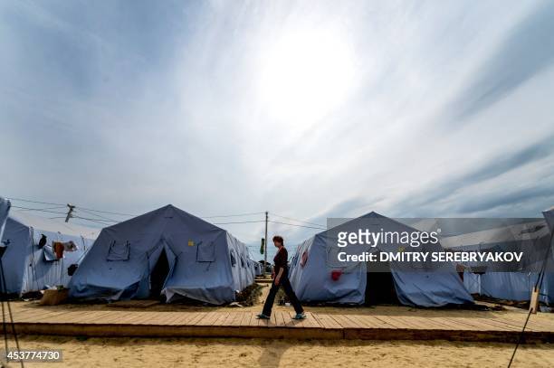 Refugee from eastern Ukraine walks in a refugee camp near the Russian city of Donets'k, Rostov region, about 15 kilometers from the Russian-Ukrainian...