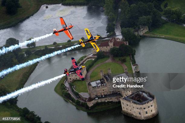 In this handout image provided by Red Bull, Matt Hall of Australia and Nicolas Ivanoff of France fly in formation with Kirby Chambliss of the United...