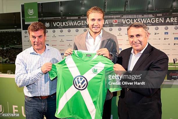 VfL Wolfsburg Sporting Director Klaus Allofs and VfL Wolfsburg Manager Dieter Hecking pose as they present New Player Nicklas Bendtner during a press...
