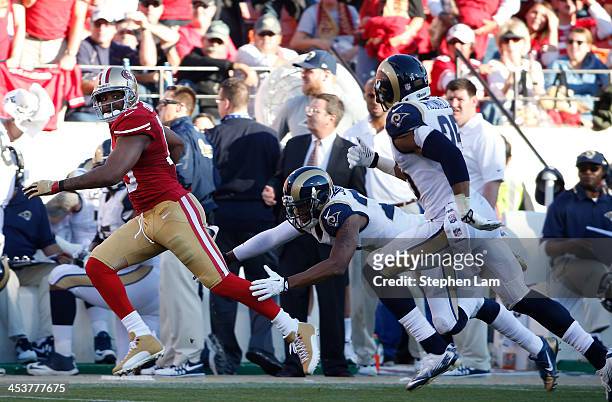 Wide receiver Michael Crabtree of the San Francisco 49ers rushes for a 60-yard gain as cornerback Trumaine Johnson and safety T.J. McDonald of the...