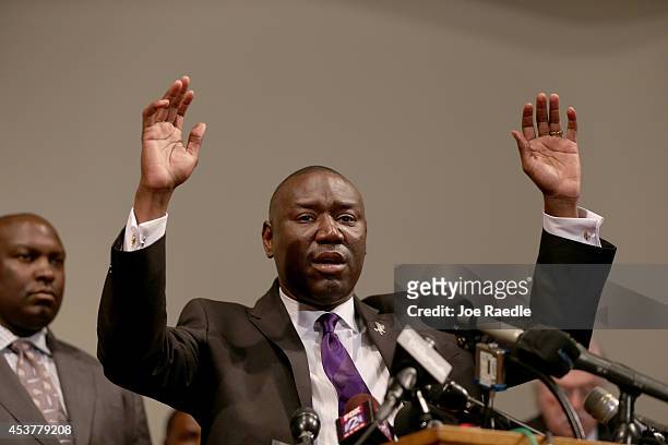The family attorney for Michael Brown, Benjamin Crump, raises his hands and speaks during a press conference where Michael Baden, a medical examiner...