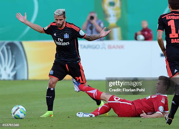 Valon Behrami of Hamburger SV is challenged by Rok Elsner of FC Energie Cottbus during the DFP Cup first round match between Energie Cottbus and...