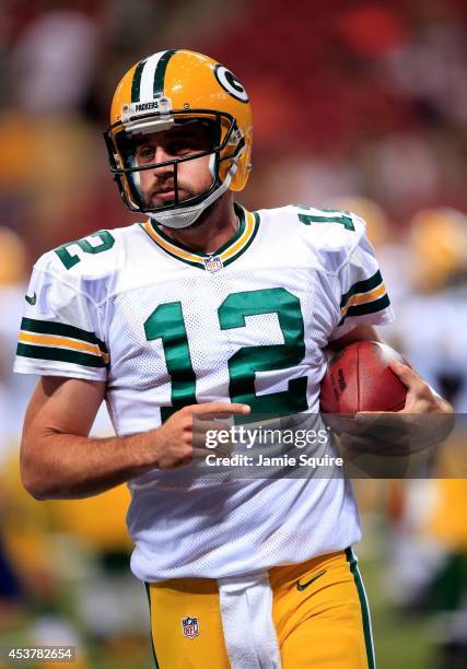 Quarterback Aaron Rodgers of the Green Bay Packers warms up prior to the preseason game against the St. Louis Rams at Edward Jones Dome on August 16,...