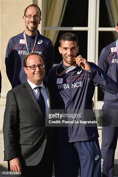 French President Francois Hollande poses with men's 1500m gold medalist Mahiedine Mekhissi-Benabbad at Elysee Palace on August 18, 2014 in Paris,...