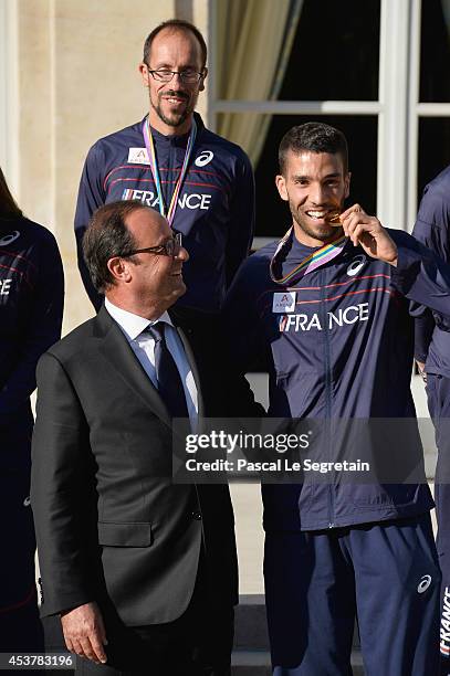 French President Francois Hollande poses with men's 1500m gold medalist Mahiedine Mekhissi-Benabbad at Elysee Palace on August 18, 2014 in Paris,...